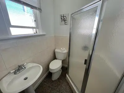 a bathroom with a toilet and a sink and a shower at Van Nuys Homes for the Soul in Los Angeles
