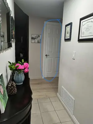 a hallway with a blue hose leading to a white door at Home sweet home in Rowland Heights
