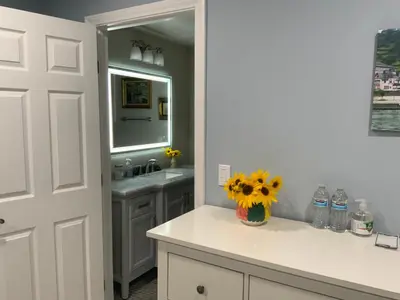 a bathroom with a sink and a vase of flowers on a counter at Home sweet home in Rowland Heights