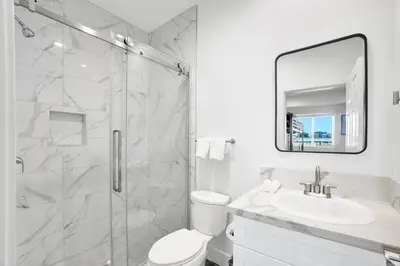 a bathroom with a shower and a toilet and a sink at Fresh & New Downtown LA Condo! in Los Angeles