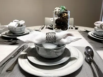 a table with a bowl and plates on a table at Cozy 2 Bedroom 2 Bathroom Condo with Pool, Gym, Spa in Los Angeles