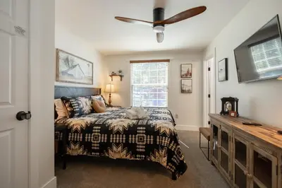 a bedroom with a bed and a ceiling fan at 37 - Foxy Farm Ranch home in Big Bear Lake