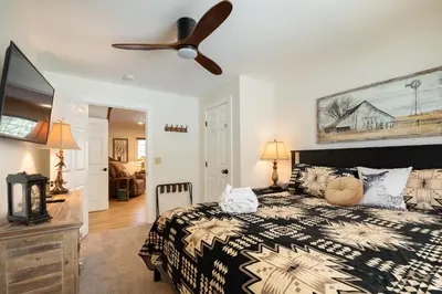 a bedroom with a bed and a ceiling fan at 37 - Foxy Farm Ranch home in Big Bear Lake