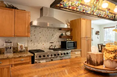 a kitchen with a stove and a microwave at 37 - Foxy Farm Ranch home in Big Bear Lake