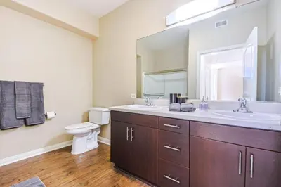 a bathroom with a sink and a toilet and a mirror at Marina del Rey 2BR - Near LAX, Beach & Dining in Los Angeles