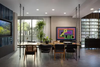 a dining room with a table and chairs and a television at Blueground Long Beach pool gym nr groceries LAX-1256 in Los Angeles