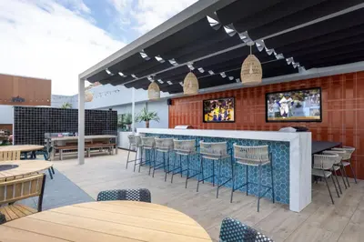 a restaurant with a bar and tables and chairs at Blueground Long Beach pool gym nr groceries LAX-1256 in Los Angeles