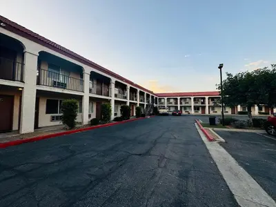 an empty parking lot in front of a building at Casa Blanca Hotel - Azusa, Los Angeles in Azusa
