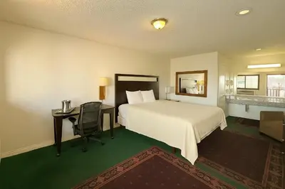 a hotel room with a bed and a desk and a bed at Casa Blanca Hotel - Azusa, Los Angeles in Azusa