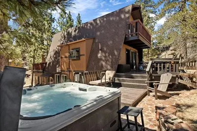 a large hot tub in front of a house at Larks Nest in Big Bear Lake in Big Bear Lake