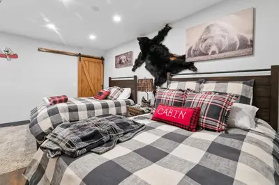 two beds in a room with at The Lazy Bear - Indulge in breathtaking views of the expansive lake from this charming cabin. in Fawnskin