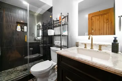 a bathroom with a toilet and a sink and a shower at The Lazy Bear - Indulge in breathtaking views of the expansive lake from this charming cabin. in Fawnskin
