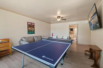 a living room with a ping pong table in it at Sunset Spectacular - Multi-level haven with water views! Incredible for 4th of July! in Big Bear Lake