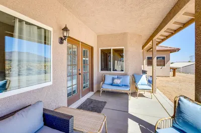 a porch with two chairs and a couch at Hesperia Home Near Mojave River and Hiking Trails! in Hesperia
