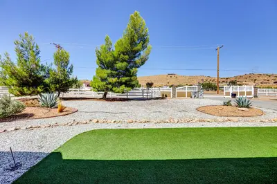 a golf course with green grass and trees at Hesperia Home Near Mojave River and Hiking Trails! in Hesperia