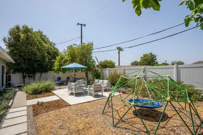 a backyard with a swing set and a playground at Spacious 3BR Home Near Disneyland & Knotts Berry Farm in Fullerton