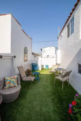 a patio with chairs and a table in a yard at Sea View, Flower Garden, AC, WD, Renovated in Hermosa Beach