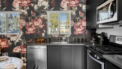 a kitchen with pink flowers on the wall at 5 Units in Heart of Hollywood Remodeled Art Deco Pink Revival by AvantStay in Los Angeles
