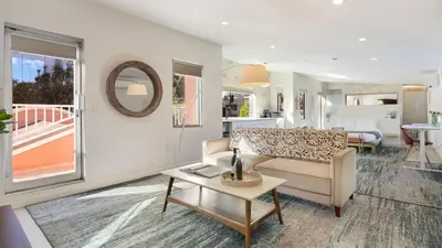 a living room with a couch and a table at 5 Units in Heart of Hollywood Remodeled Art Deco Pink Revival by AvantStay in Los Angeles