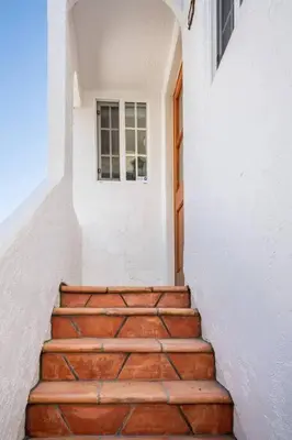 a set of stairs leading to a door in a building at 2min2Beach, Netflix, AC, WD,15min2LAX, Fast Wifi in Hermosa Beach