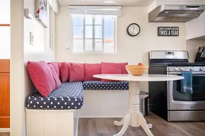 a living room with a red couch and a table at 2min2Beach, Netflix, AC, WD,15min2LAX, Fast Wifi in Hermosa Beach