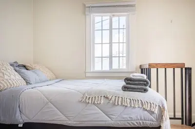 a bedroom with a bed with towels on it at 2min2Beach, Netflix, AC, WD,15min2LAX, Fast Wifi in Hermosa Beach