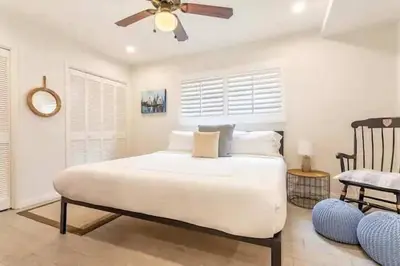 a bedroom with a white bed and a ceiling fan at Walk 2 Beach, Parking, AC, WD,15min2LAX,Remodel in Manhattan Beach
