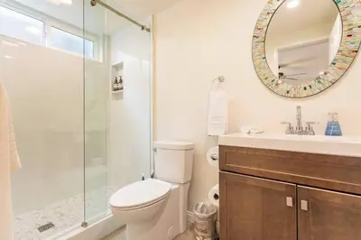 a bathroom with a toilet and a sink and a mirror at Walk 2 Beach, Parking, AC, WD,15min2LAX,Remodel in Manhattan Beach