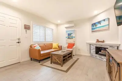 a living room with a couch and a fireplace at Walk 2 Beach, Parking, AC, WD,15min2LAX,Remodel in Manhattan Beach