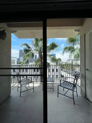 a balcony with chairs and a view of the ocean at SoCal Lux on Miramar in Los Angeles