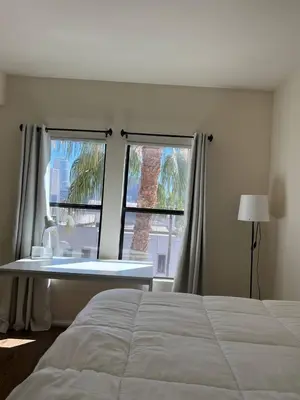 a bedroom with a bed and two windows at SoCal Lux on Miramar in Los Angeles