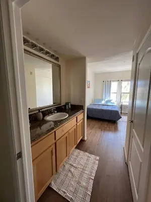 a bathroom with a sink and a large mirror at SoCal Lux on Miramar in Los Angeles