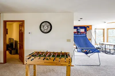 a game room with a table and a slide at Simple Life Ranch with Hot Tub and Sauna in Keene! in Keene