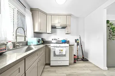 a kitchen with white cabinets and a stove top oven at Great Location Oasis w Huge Backyard Near DTLA ,USC ,Ktown in Los Angeles