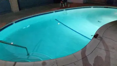 a large swimming pool with blue water at Kona Inn Motel Anaheim in Anaheim