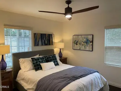 a bedroom with a bed with a ceiling fan at Glendale Hills Hideaway in Glendale