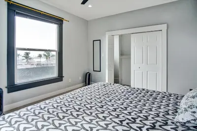 a bedroom with a bed and a window at Ventura Downtown Minutes to Beaches in Ventura