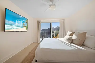 a white bedroom with a bed and a large window at Aquamarine Best View in Malibu by Stay Awhile Villas in Malibu Beach