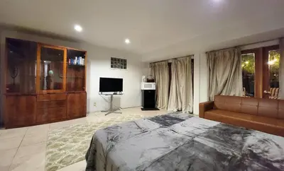 a large bedroom with a bed and a television at Private guest studio 5 minutes to Rodeo Drive and in great area in Los Angeles