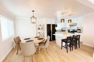 a kitchen and dining room with a table and chairs at Spacious 3BR Modern Home in LA Perfect for Family in El Monte