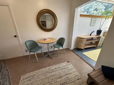 a room with a table and two chairs and a mirror at Topanga Panoramic View Loft with Trails & Creeks in Topanga