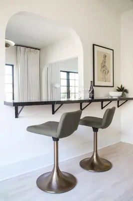 a dining room table with two chairs and a mirror at Hotel Covell in Los Angeles