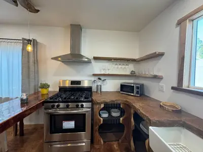 a kitchen with a stove and a counter top at Vacation House in Ontario - Two Bedroom Brand New and Hand Made Furniture in Ontario