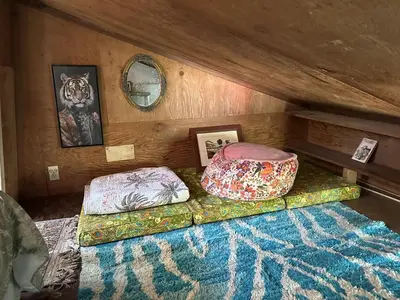 a bedroom with two beds in a room with a ceiling at Topanga Wonderland Cottage in Topanga