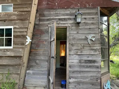 an open door of a wooden building with a door sidx sidx sidx at Topanga Wonderland Cottage in Topanga
