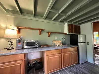 a kitchen with a counter top with a microwave at Topanga Wonderland Cottage in Topanga