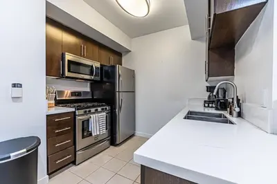 a kitchen with a sink and a stove top oven at Stylish 2BDR & 2BTH - 15 mins walk to the beach! in Los Angeles