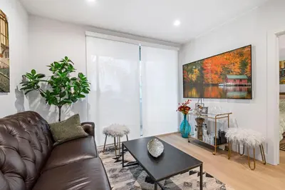 a living room with a leather couch and a table at 15 City View Santa Monica in Los Angeles