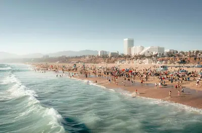 a large group of people on a crowded beach at 15 City View Santa Monica in Los Angeles