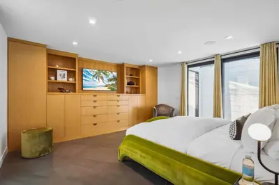 a bedroom with a large bed and a television at The Elvis Villa by Stay Awhile Villas in Los Angeles